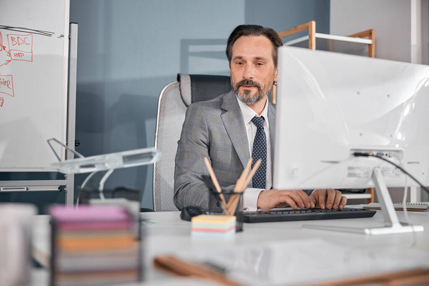 Male worker using modern computer in office - Фото, изображение
