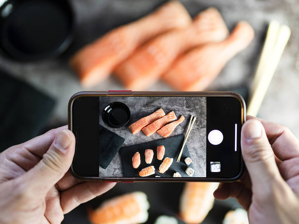 gesture of taking photos by hand of delicious traditional food. blogger concept - Φωτογραφία, εικόνα