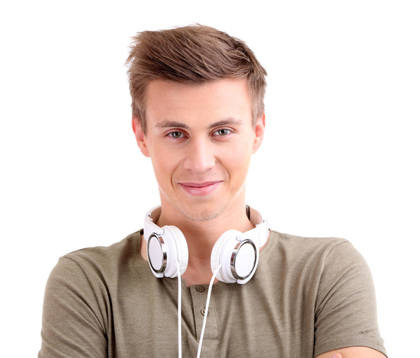 Handsome young man listening to music isolated on white - Fotó, kép