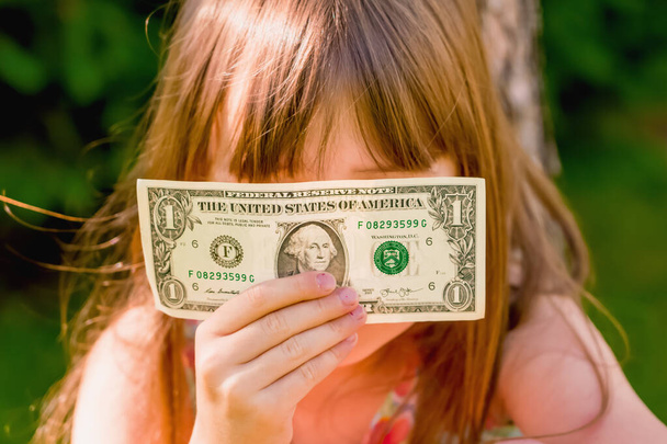 Business in my mind! Young beautiful girl with one US Dollar banknote.  - Photo, Image