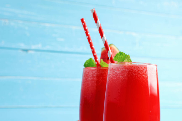 Cold watermelon smoothie drinks in the glass on blue wooden background with copy space. Drinks refreshing for the healthy of summer. - Foto, imagen
