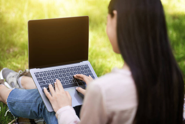 Mockup Image Of Woman Working On Laptop With Black Screen Outdoors - Zdjęcie, obraz