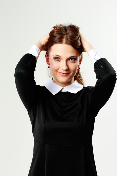 Woman in casual dress touching her head - Foto, Imagen