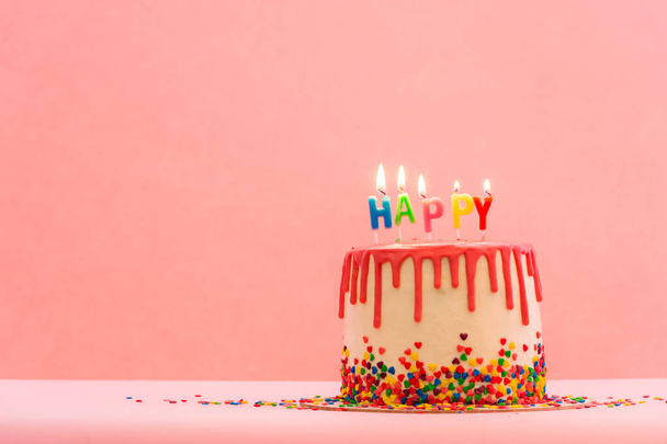 国際幸福の日。ピンクのケーキを背景に幸せな母の日。ピンクの誕生日ケーキ色の背景。"ハッピー・キャンドル"。火事だ。テキストのスペース - 写真・画像