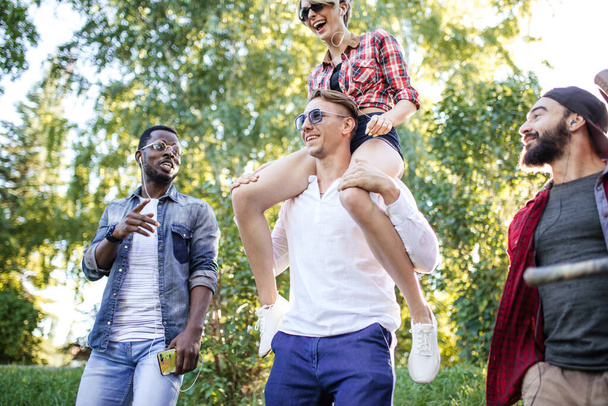 Multicultural group of friends walking together and having fun day outdoors. - 写真・画像