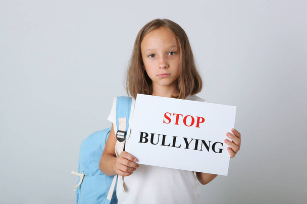 Sad girl holding a stop bullying sign - Фото, изображение