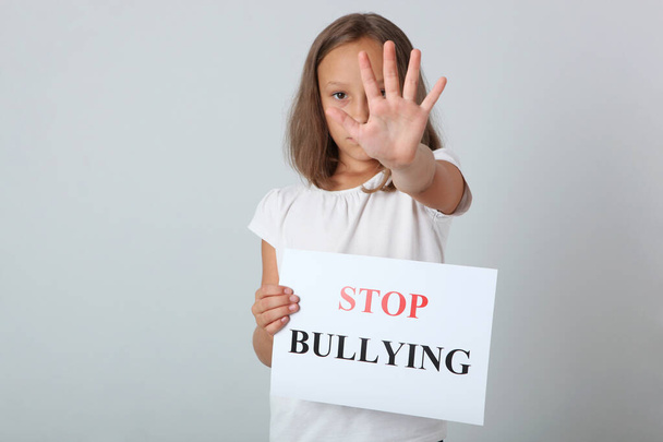 Sad girl holding a stop bullying sign - Foto, Imagen