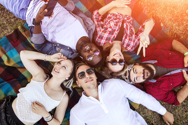 Friends in the park having fun and making a group selfie - Foto, Imagen