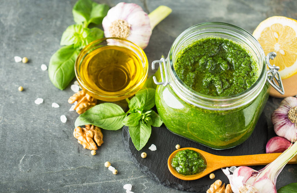Fresh pesto sauce and ingredients in the glass jar - Photo, image