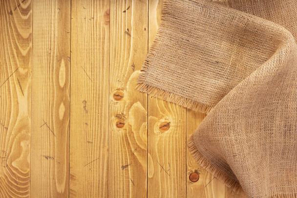 burlap hessian sacking texture on old wooden background, table surface - Valokuva, kuva