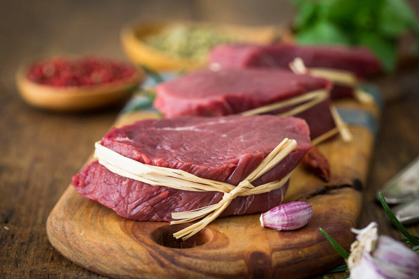 Raw organic beef steak with spices - Photo, Image
