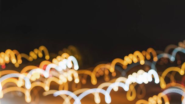 Blurry image of night lights on the street - Foto, afbeelding