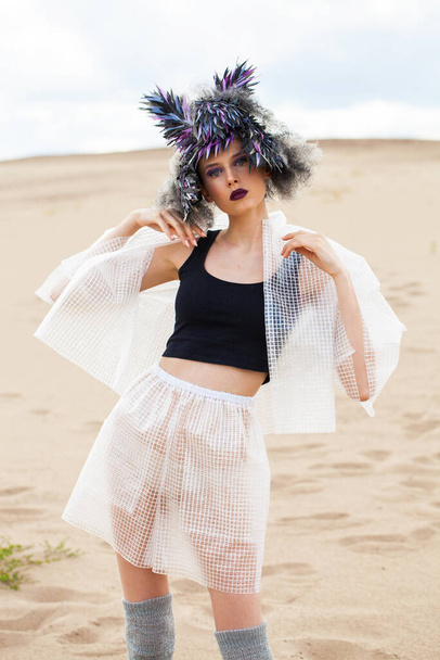 portrait of fashion model in designer clothes with a bird feather wig - 写真・画像