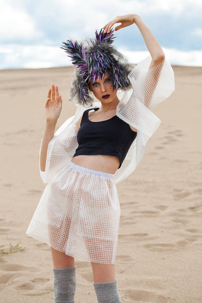 portrait of fashion model in designer clothes with a bird feather wig - Foto, Bild