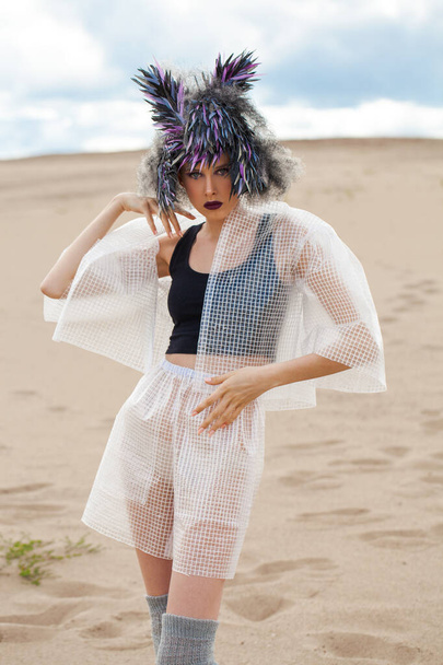 portrait of fashion model in designer clothes with a bird feather wig - Fotoğraf, Görsel