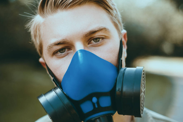 Close up portrait of young man with respirator outdoor during lockdown - Photo, Image