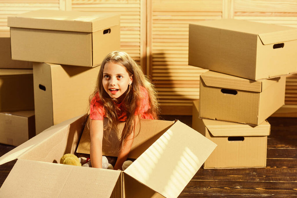 It Starts Here. purchase of new habitation. Cardboard boxes - moving to new house. Moving concept. new apartment. happy little girl with toy. happy child cardboard box - Φωτογραφία, εικόνα