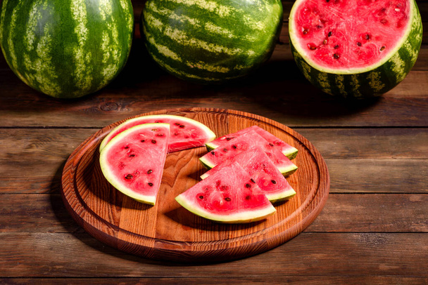 Frische köstliche Wassermelone in Scheiben geschnitten mit Minze und Wassermelonensaft. Sommerliche Wassermelonenernte - Foto, Bild