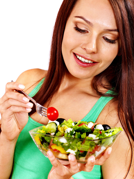 Woman eating salad at kitchen. - Foto, Imagem