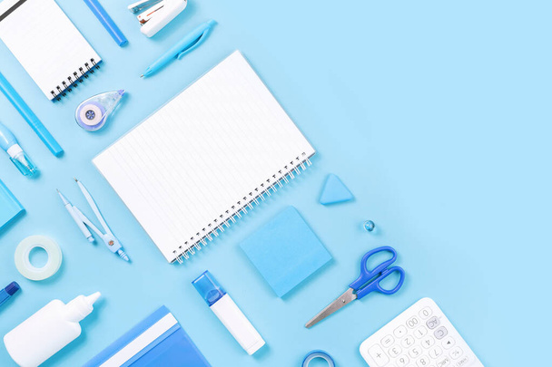 Assorted office and school white and blue stationery on pastel background as border. Flat lay knolling with copy space for back to school or education and craft concept. Blue monochrome banner - Photo, Image