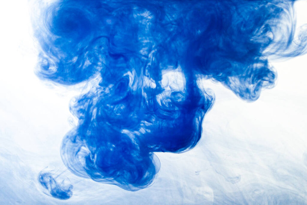 A cloud of blue paint released into clear water. Isolate on a white background. - Fotografie, Obrázek