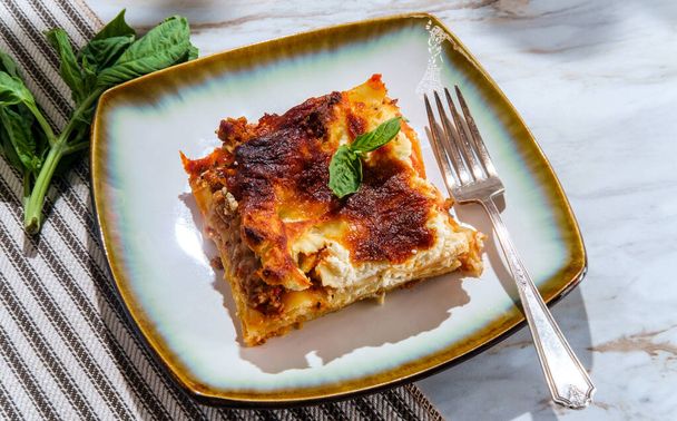 Hausgemachte italienische Backkäse-Fleisch-Lasagne auf Marmor-Küchentisch - Foto, Bild