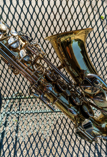 Outdoor Jazz entertainment musical instrument saxophone with grungy street background - Photo, Image