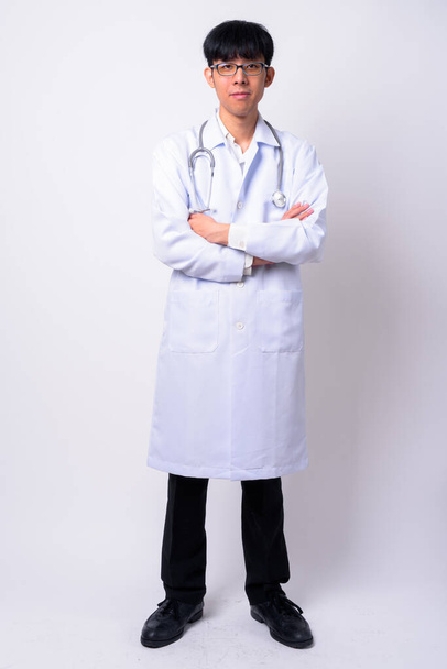 Studio shot of young handsome Asian man doctor against white background - Φωτογραφία, εικόνα