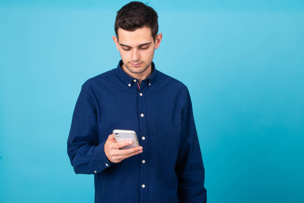 portrait of young man with mobile phone isolated on background - Φωτογραφία, εικόνα