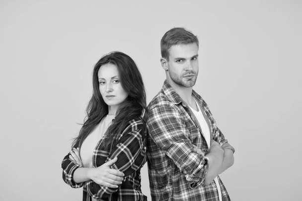 Family look. People concept. Family relations. Adult siblings. Sister and brother. Confident team. Back to back standing man and woman. Fashion clothes shop. Modern couple. Couple checkered shirts - Foto, imagen