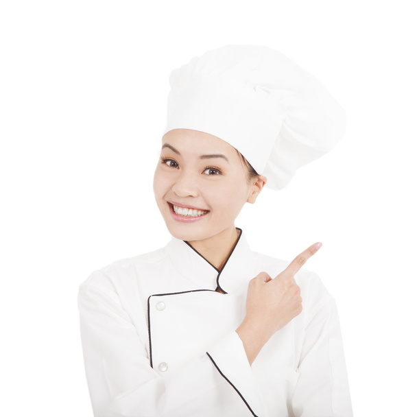 Aziatische jonge vrouw chef-kok richting wijzen - Foto, afbeelding
