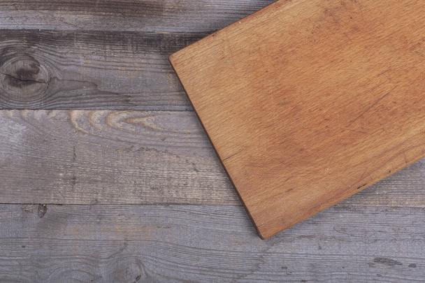 kitchen cutting board on dark gray wooden background - Фото, изображение