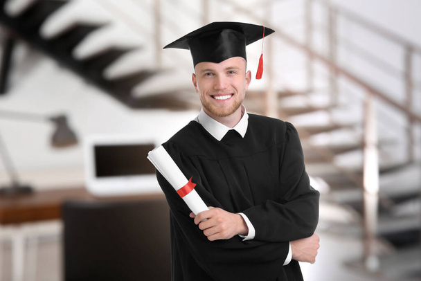 Happy student with graduation hat and diploma in office - Valokuva, kuva