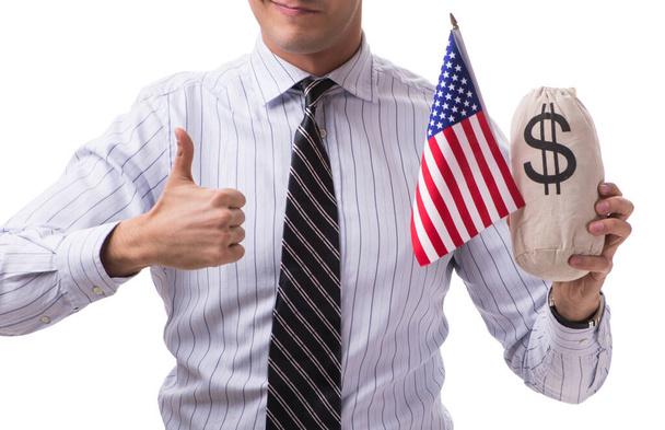 Jonge zakenman met Amerikaanse vlag en geld zak op wit - Foto, afbeelding