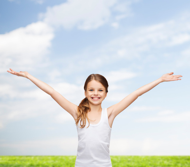 Smiling teenage girl with raised hands - Zdjęcie, obraz