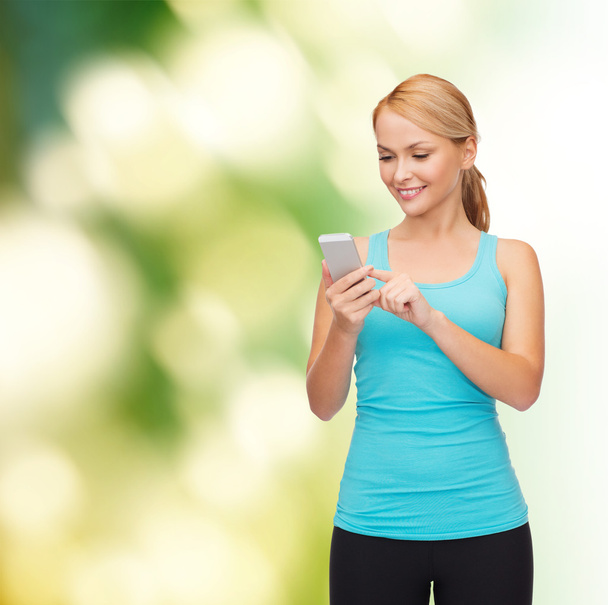 Sporty woman with smartphone - Photo, image