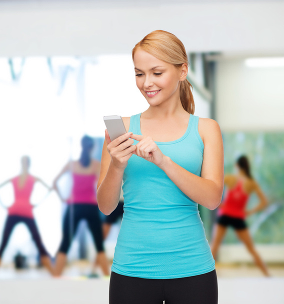 Sporty woman with smartphone - Foto, imagen
