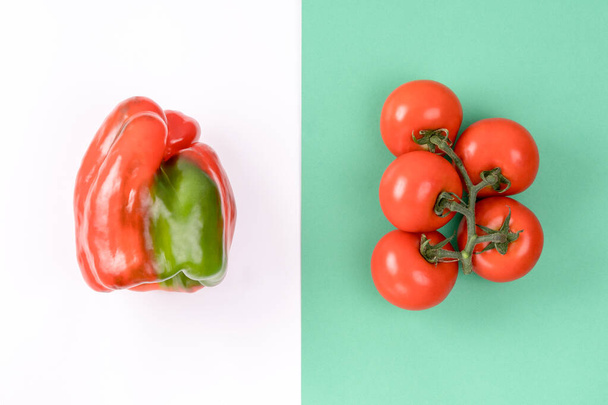Creative layout made of pepper and tomato on colorful green and white background. Minimal summer concept. Ingredients for salad. Vegetable design. - Photo, Image