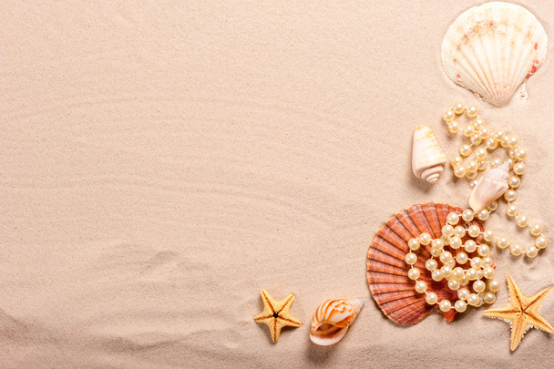 pearl beads and seashells in the sand - Photo, Image