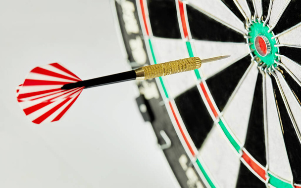 Darts on a white background. 1 dart flies directly to the center of the target. Business center goal concept. - Photo, Image