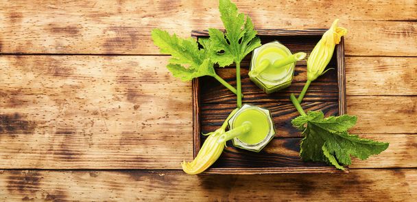 Healthy green smoothie with zucchini in glass jars on a rustic wooden background.Healthy drink,vegetable smoothie - Foto, imagen