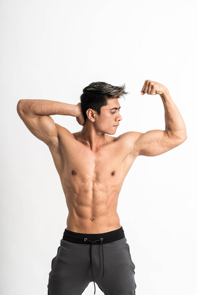 young man showing muscular biceps stand facing forward - 写真・画像