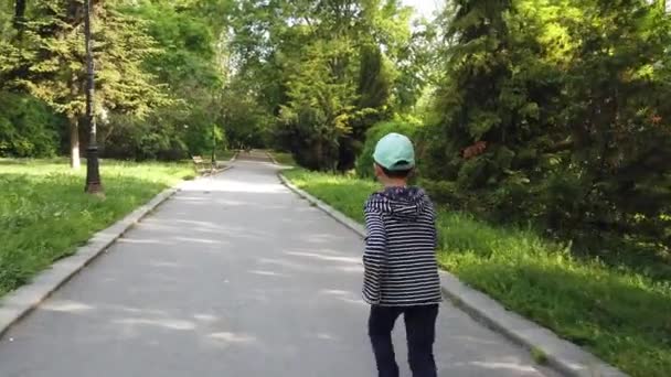 Little boy running outside in the park. Playing chase with his father.  Catch Me If You Can. Father and son chasing each other at the park - Video, Çekim