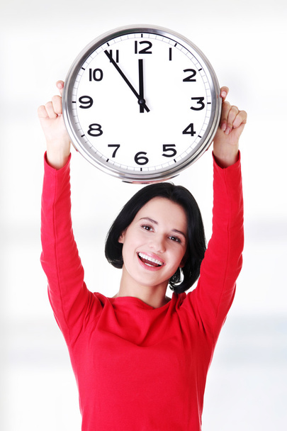 Happy young woman holding office clock - Φωτογραφία, εικόνα
