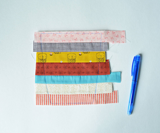 Work in process: colorful fabric scraps and marking pen over white  - Valokuva, kuva
