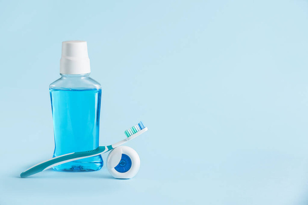 Tooth brush, mouth rinse and paste on color background - Photo, Image