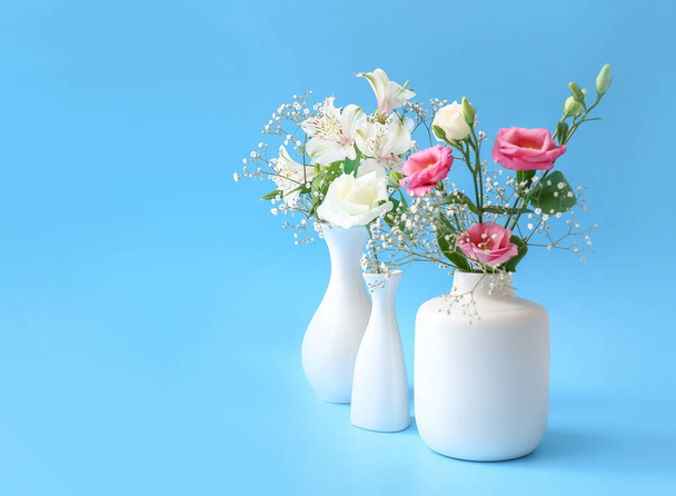 Beautiful vases with flowers on color background - Fotó, kép