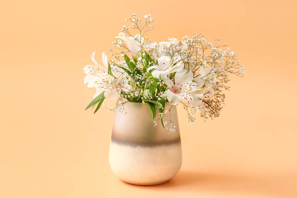 Beautiful vase with flowers on color background - 写真・画像