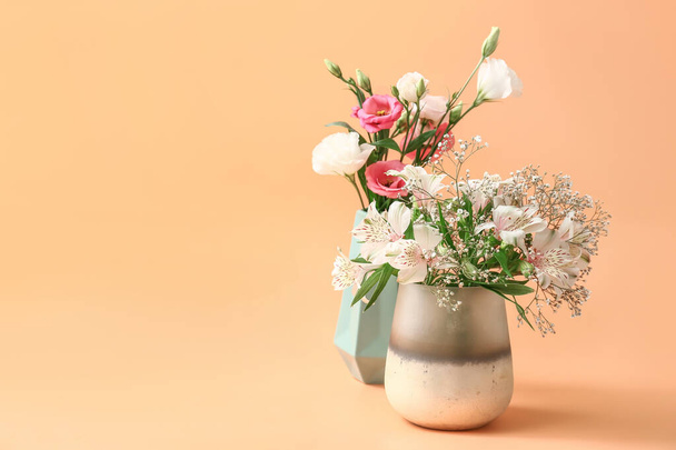 Beautiful vases with flowers on color background - Photo, Image