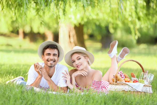 Happy young couple on picnic in park - Foto, imagen